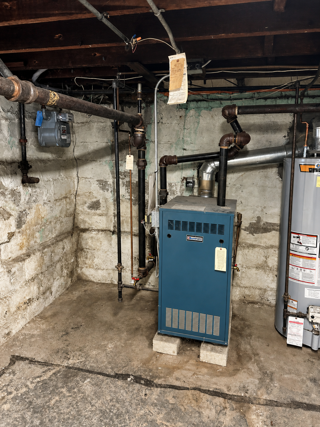 Old gas boiler before removal during Melrose home HVAC renovation