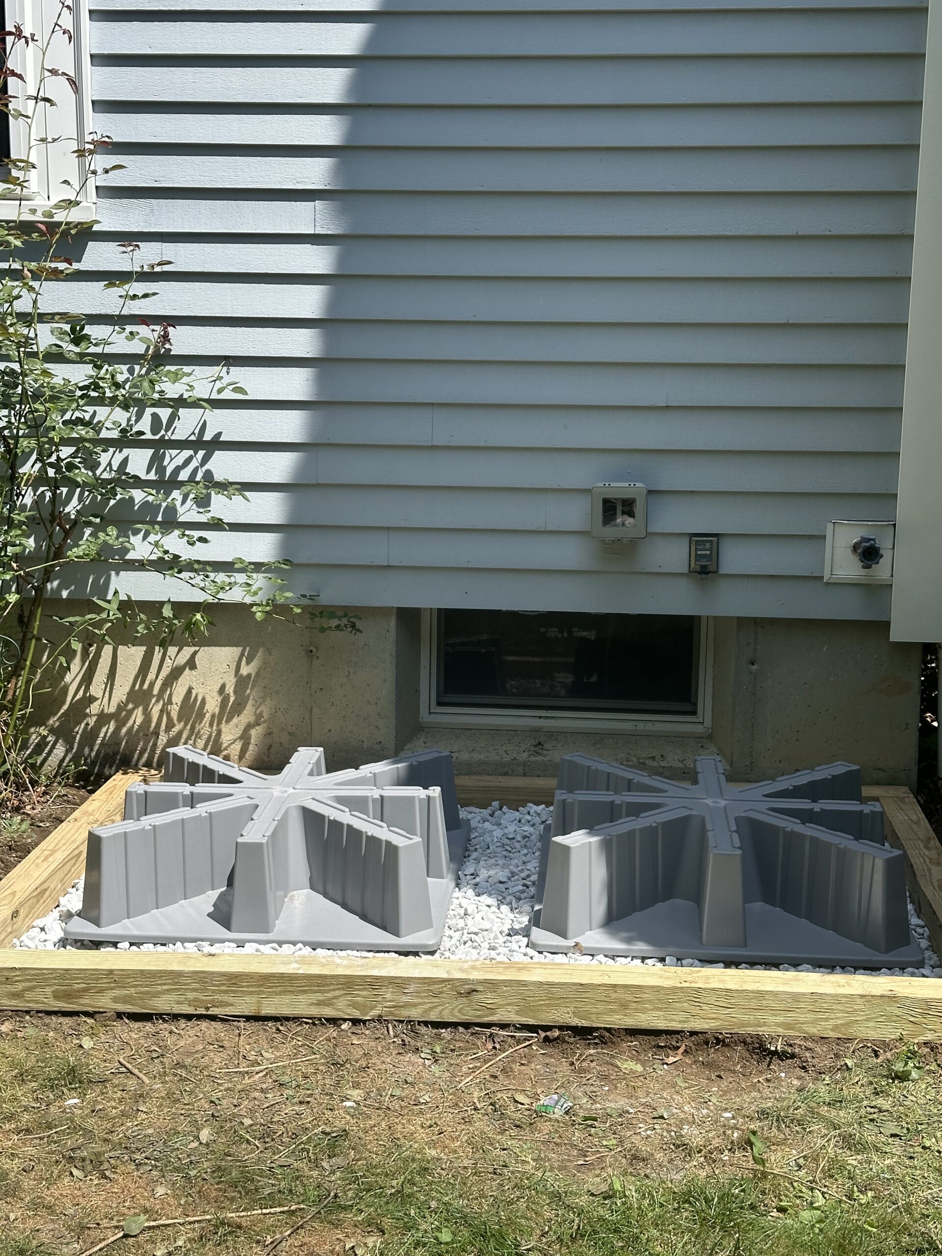 Crushed stone base and elevated supports prepared for two air conditioning condensers