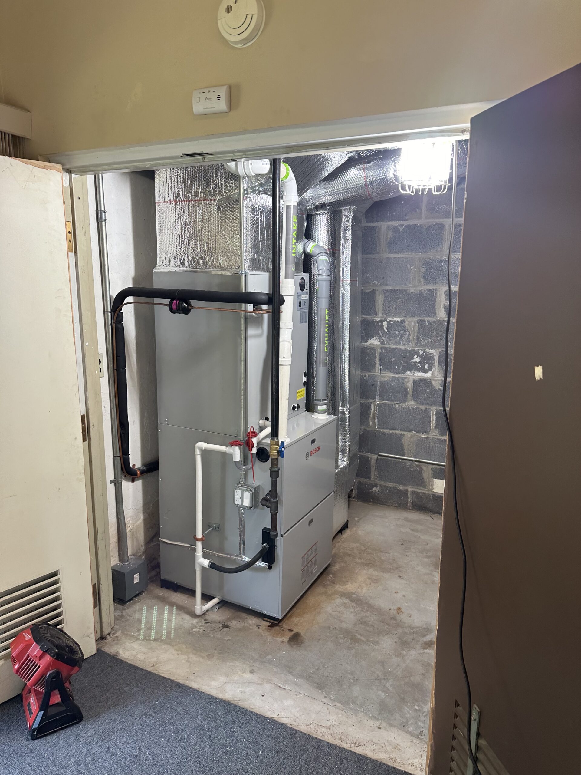 Completed residential furnace installation with custom ductwork